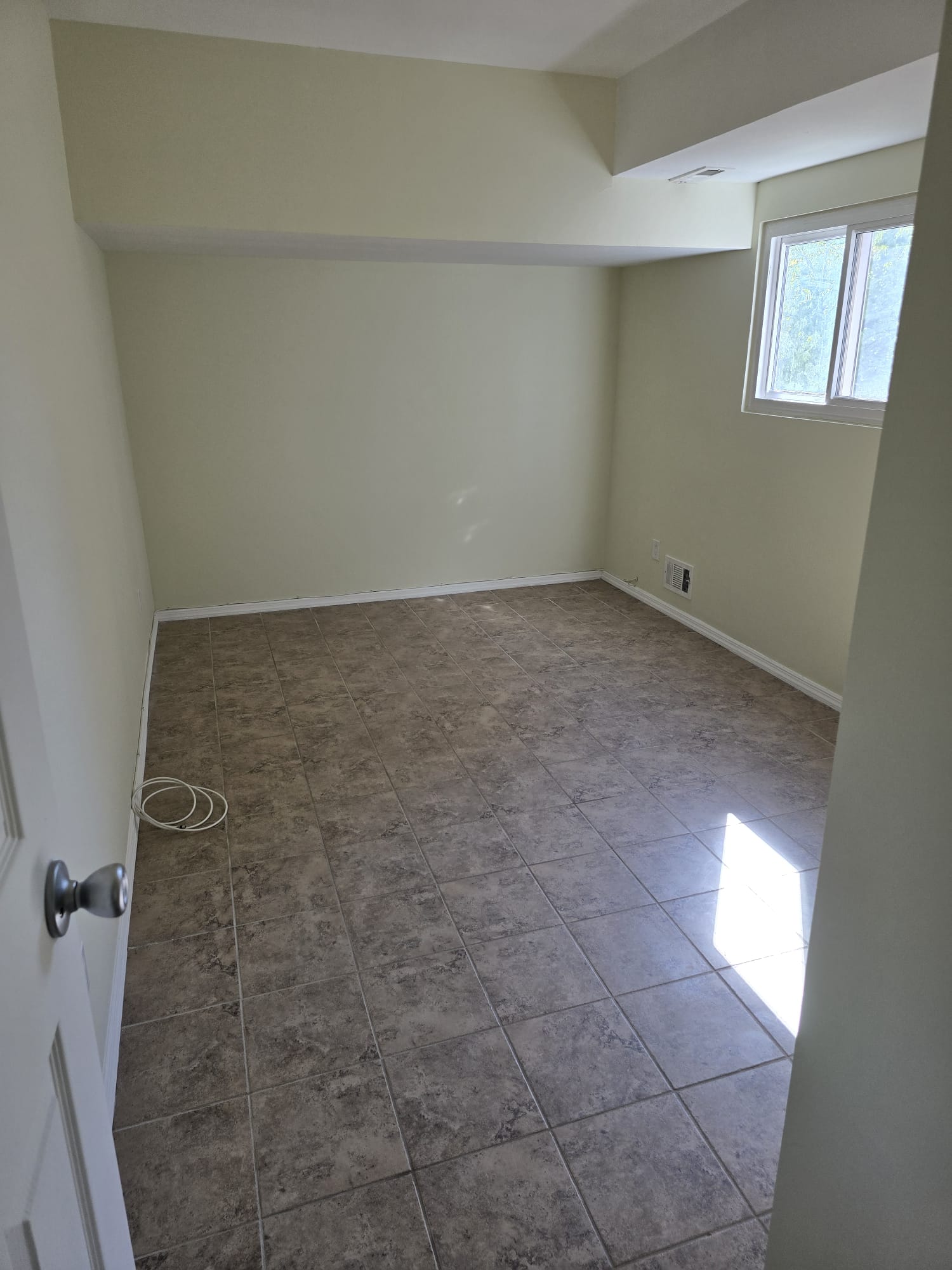 Staten Island 1BR — bedroom with tile floor and window